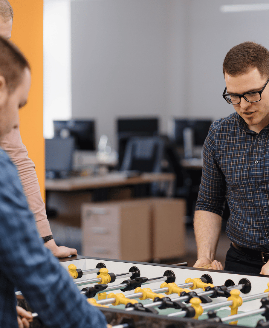 Young Office Workers Playing Table Soccer